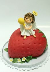 Cake in the shape of a strawberry with an angel on top.JPG