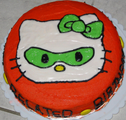 Green masked hello kitty cake in bright red and round shape.PNG