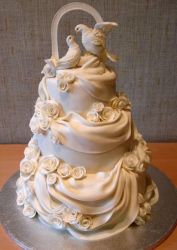 Doves and white drapes 3 tier wedding cake