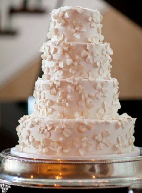 4 tier round white wedding cake with mini white flowers.JPG