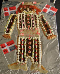 Viking danish kagemand with fancy cake decor with cake cream and candy and large danish birthday flags.PNG