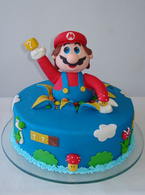 Round blue cake with Super Mario poppping out.JPG