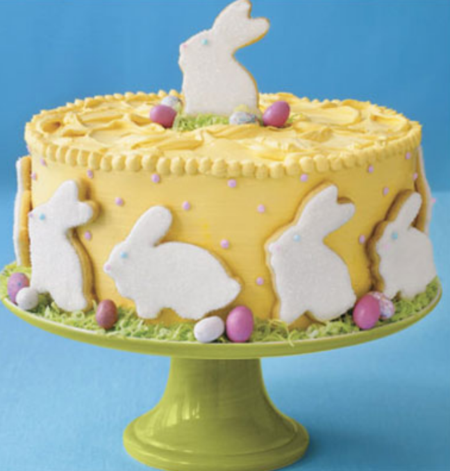 Yellow Easter cake with bunny cake toppers.PNG