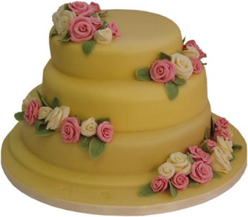 bright yellow wedding cake with small roses
