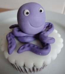 Chocolate cup cake with purple octopus on top.JPG