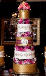 5 tier tall wedding cake with 3 gold tiers and 2 white tiers and fresh roses in between.JPG