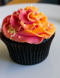 Chocolate cupcake with red and orange cream on top.JPG