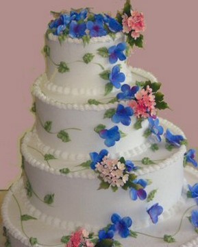 round wedidng cake with colorful flowers