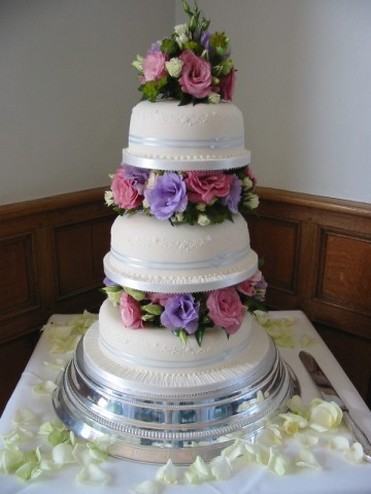 round white wedding cake with colorful roses