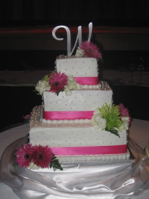 square white wedding cake with pink flowers and lines
