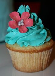 Cupcake with blue cream and pink flower.JPG