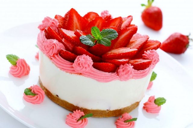 Round strawberry cream birthday cake with fresh strawberries on top.JPG