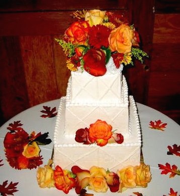 wedding cake with bright color roses