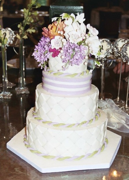 white wedding cake with fresh flowers topper