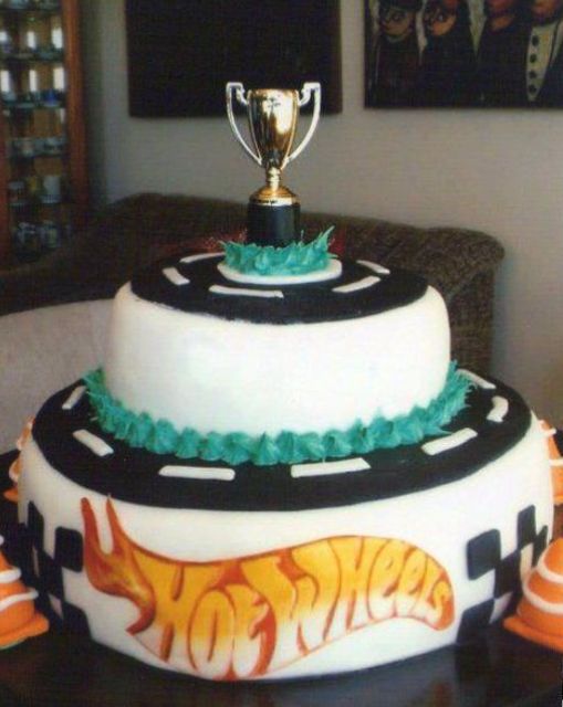 2 tier Hot Wheels theme cake with trophy cup on top.JPG
