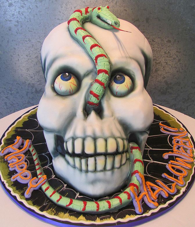 Halloween skull cake with bulging eyeballs and snake.JPG