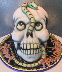 Halloween skull cake with bulging eyeballs and snake.JPG