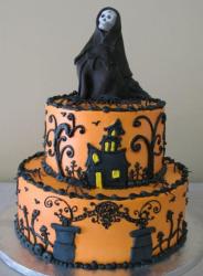 2 tier orange Halloween cake with skeleton in black cape on top.JPG