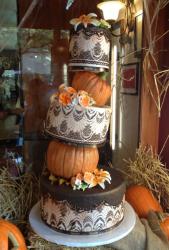 5 tier Halloween theme wedding cake with pumpkins as two of the tiers.JPG