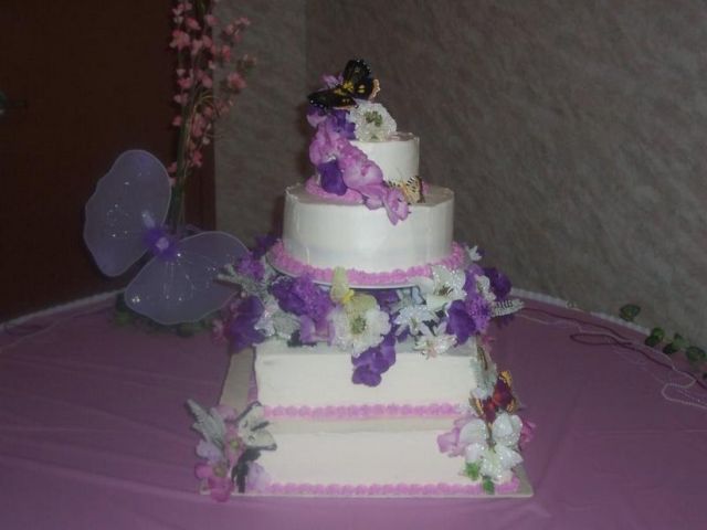 square and round wedding cake with purple flowers