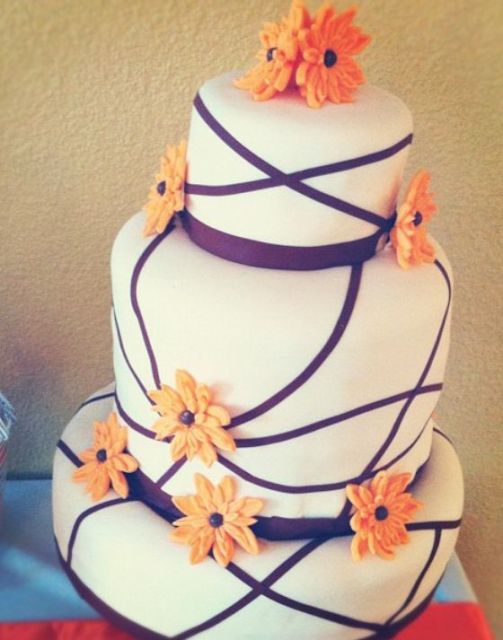 3 tier white round cake with orange flowers.JPG