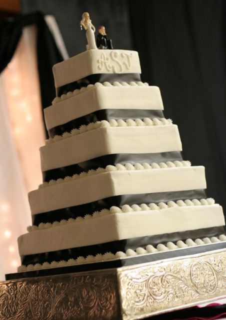Five-tier square wedding cake with bride and groom toppers.JPG