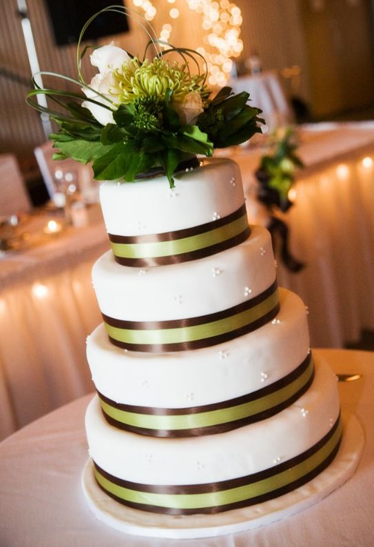 Four tier round white wedding cake with chocolate ribbons.JPG