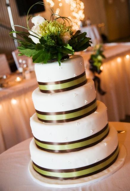 Four tier round white wedding cake with chocolate ribbons.JPG