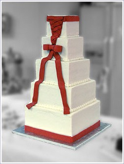 Five tier square wedding cake with red ribbons