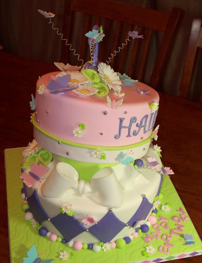 Cool two tier birthday cake with bowties and butterflies.JPG