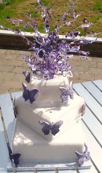 Three tier square white weddign cake with lavender butterflies and crystal topper.JPG