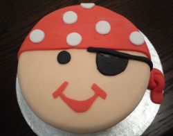 Round happy Pirate face birthday cake.JPG
